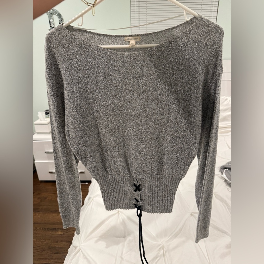 Silence + Noise grey long sleeve sweater top with black tie detail at bottom